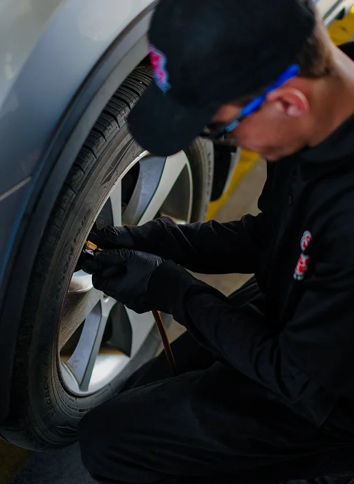 Man putting air in a car tire
